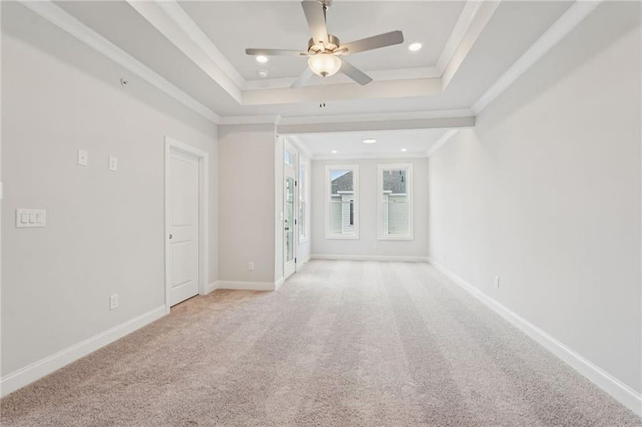 Carpeted spare room featuring ceiling fan, recessed lighting, and ornamental molding