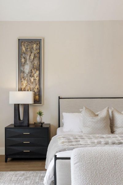 Hardwood floors complement a serene bedroom, creating a tranquil retreat for peaceful rest.