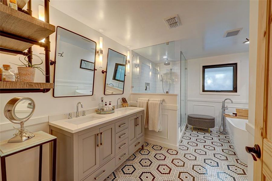 Tastefully appointed primary bath features elegant soaking tub, separate oversized walk-in shower, wainscoting detail. 94 San Saba St., AustinTX 78702 MLS# 7207900