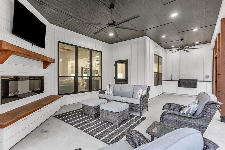 Back porch with fireplace and outdoor kitchen. Back porch with fireplace and outdoor kitchen.