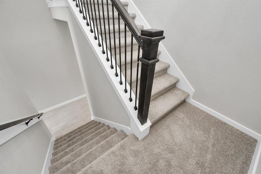 Premium carpet and metal balusters throughout. Sample photo of completed home with similar plan. As built color and selections may vary.