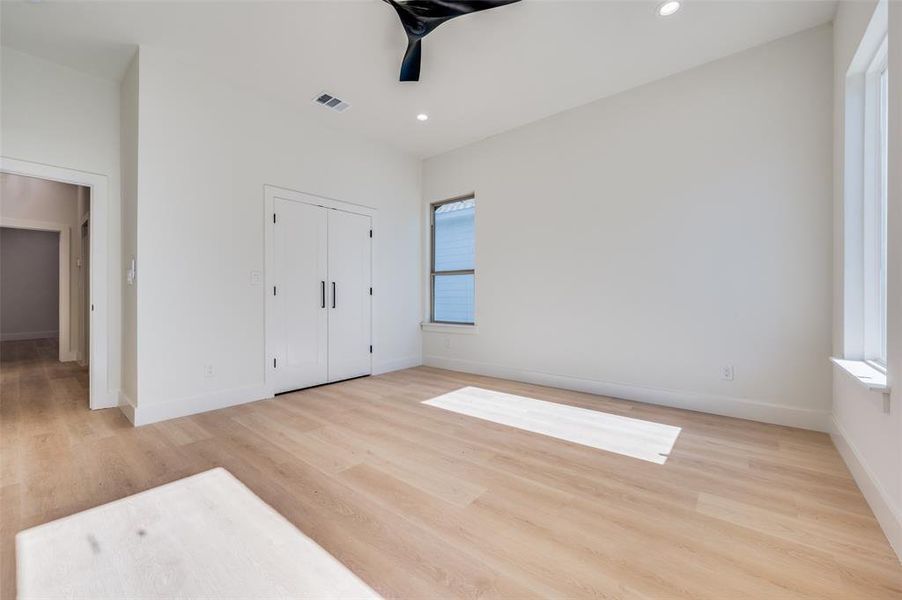 Unfurnished bedroom featuring a closet and light hardwood / wood-style floors