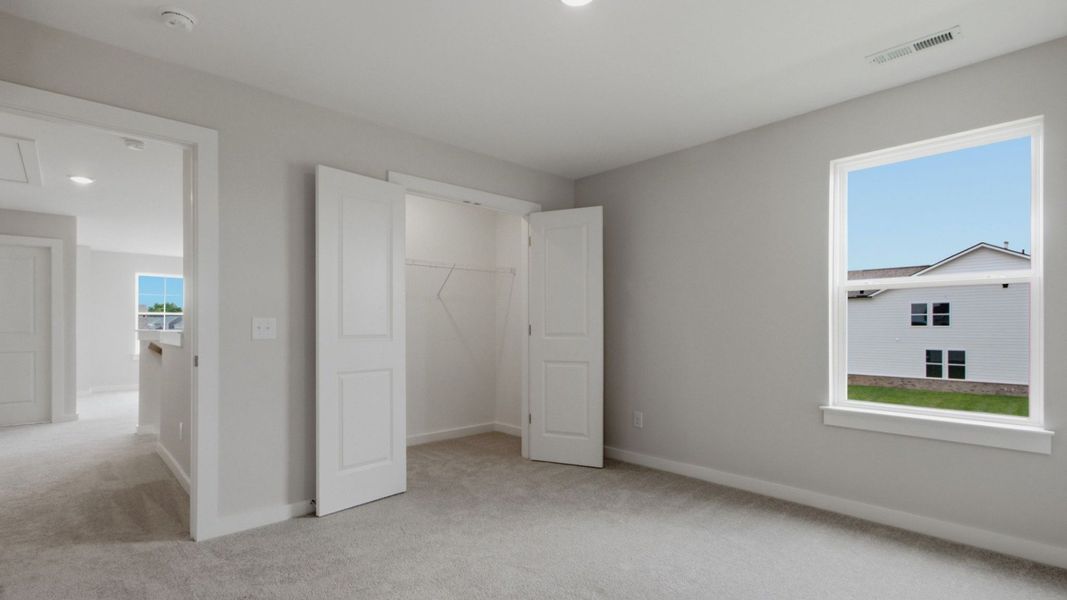 Upstairs secondary bedroom with closet