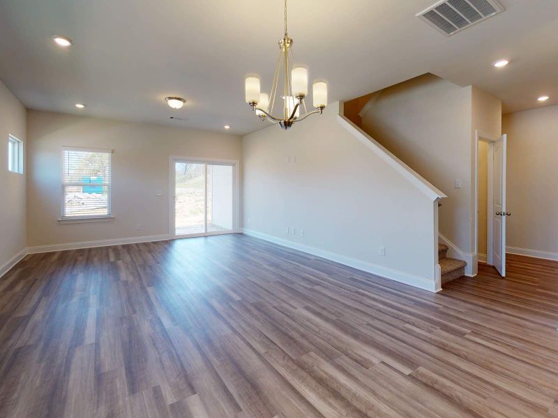 The open-concept floorplan takes you from the kitchen to the living and dining areas. The open-concept floorplan takes you from the kitchen to the living and dining areas.