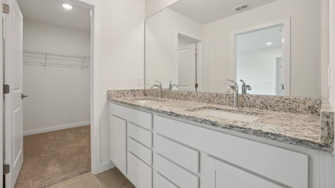 Primary suite with en suite Bath of the Coronado - End at Cyrene at Harmony located in St Cloud FL by DRB Homes
