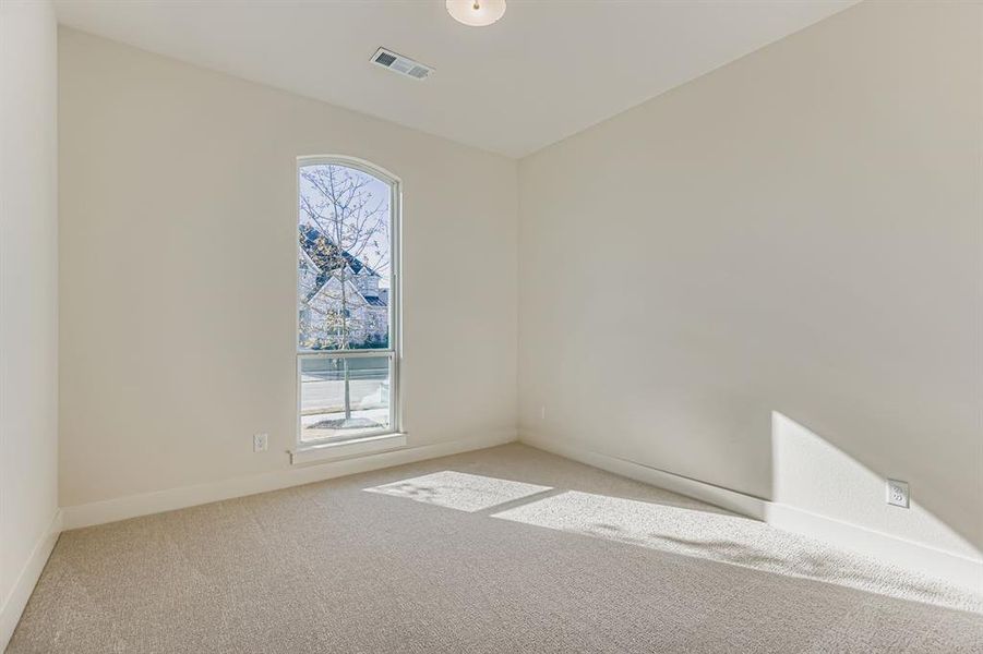 Carpeted spare room with baseboards