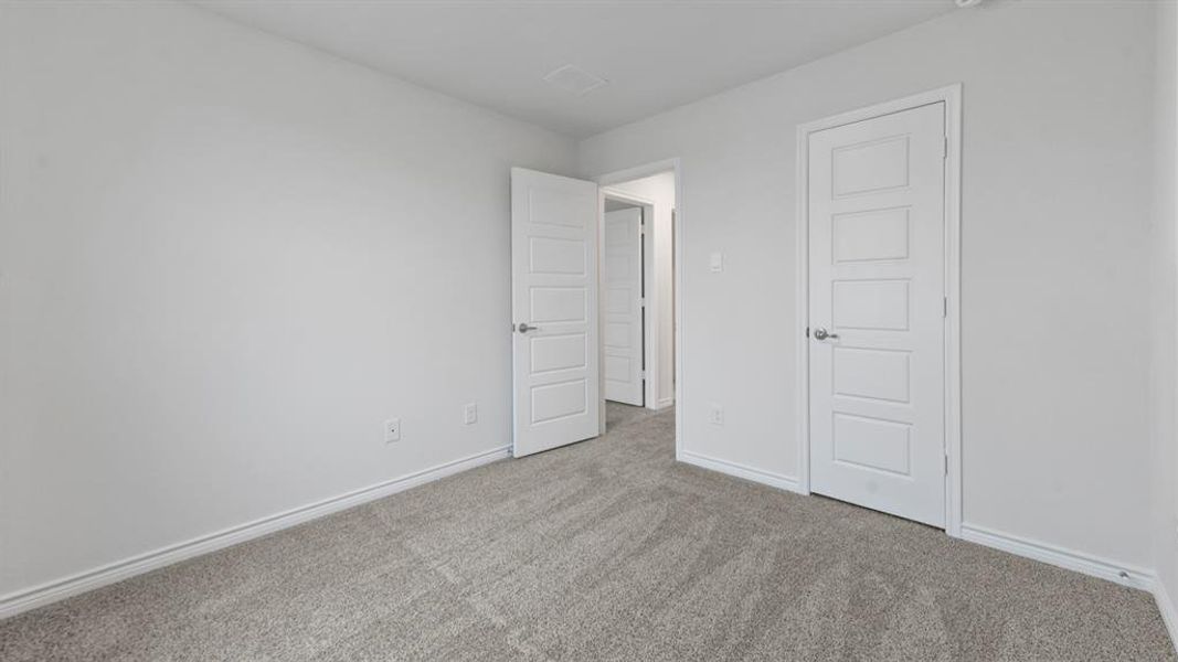 Room featuring light gray carpet, white walls, and contemporary five-panel interior doors