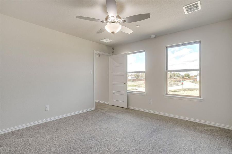 Spare room with light carpet and ceiling fan