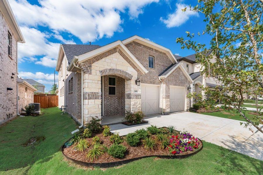 Front exterior of a new home in Spiritas Ranch, Little Elm, TX, highlighting curb appeal (Image 20). Front exterior of a new home in Spiritas Ranch, Little Elm, TX, highlighting curb appeal (Image 20).