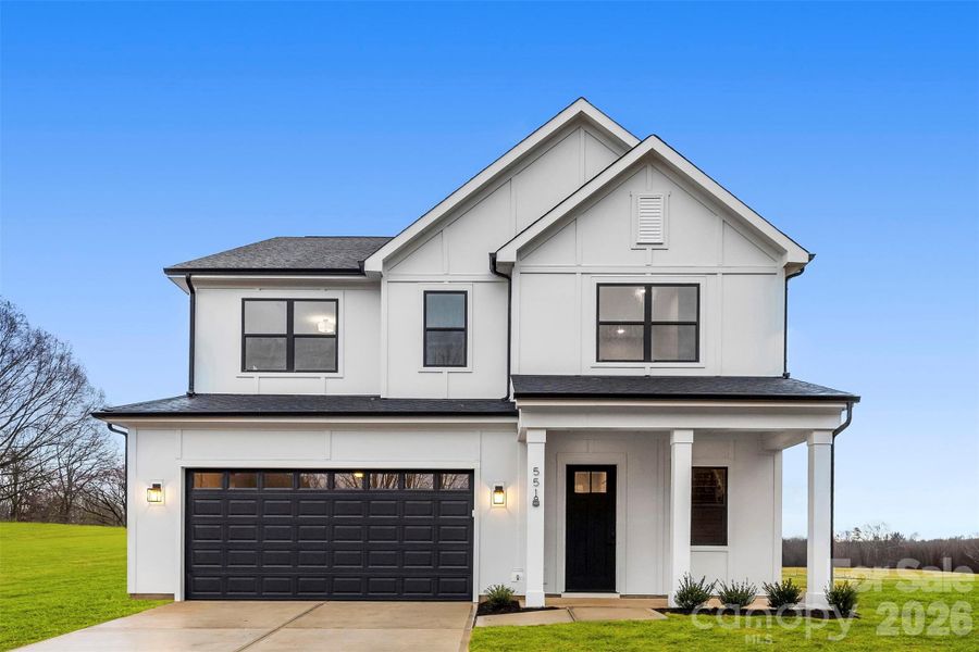 Front exterior of a new home in , Troutman, NC, highlighting curb appeal (Image 28).