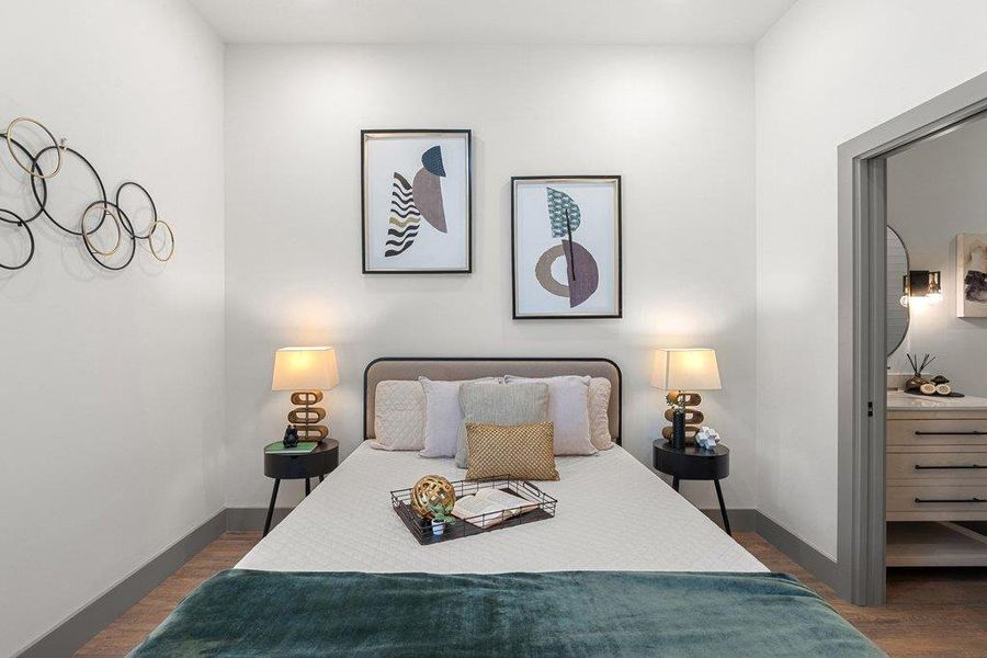 Bedroom featuring dark wood-type flooring and baseboards