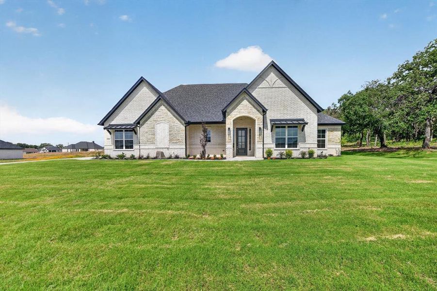 Front exterior of a new home in , Azle, TX, highlighting curb appeal (Image 2). Front exterior of a new home in , Azle, TX, highlighting curb appeal (Image 2).