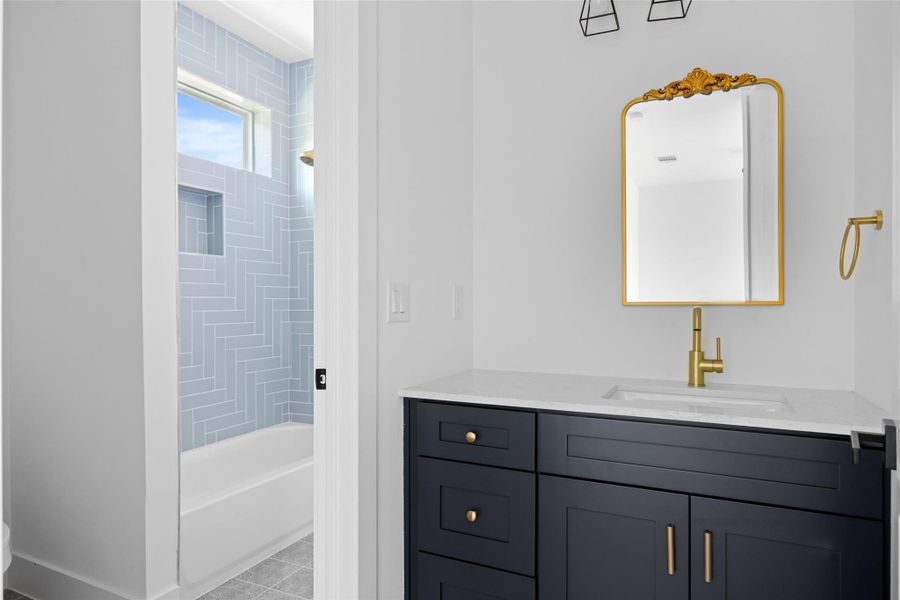 Bathroom with vanity, shower / bath combination, and light tile patterned flooring Bathroom with vanity, shower / bath combination, and light tile patterned flooring