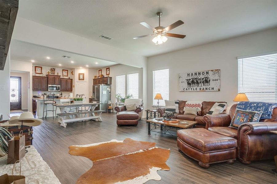 Living area featuring dark wood-style floors, plenty of natural light, ceiling fan, and recessed lighting Living area featuring dark wood-style floors, plenty of natural light, ceiling fan, and recessed lighting
