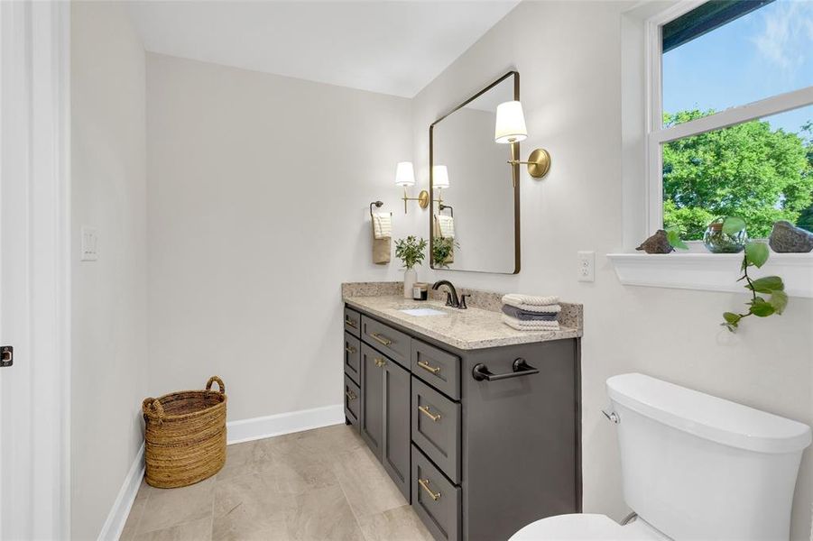 Bathroom featuring vanity and baseboards Bathroom featuring vanity and baseboards