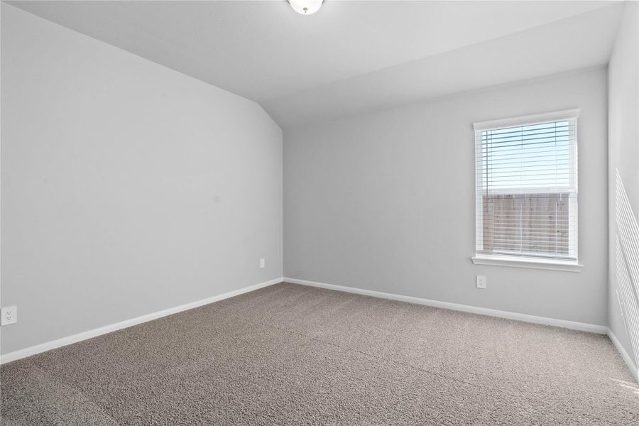 Perfect for guests or a quiet home office, this room features soft plush carpeting, a window with fitted blinds, sloped ceiling, and ample sized closet space. Perfect for guests or a quiet home office, this room features soft plush carpeting, a window with fitted blinds, sloped ceiling, and ample sized closet space.