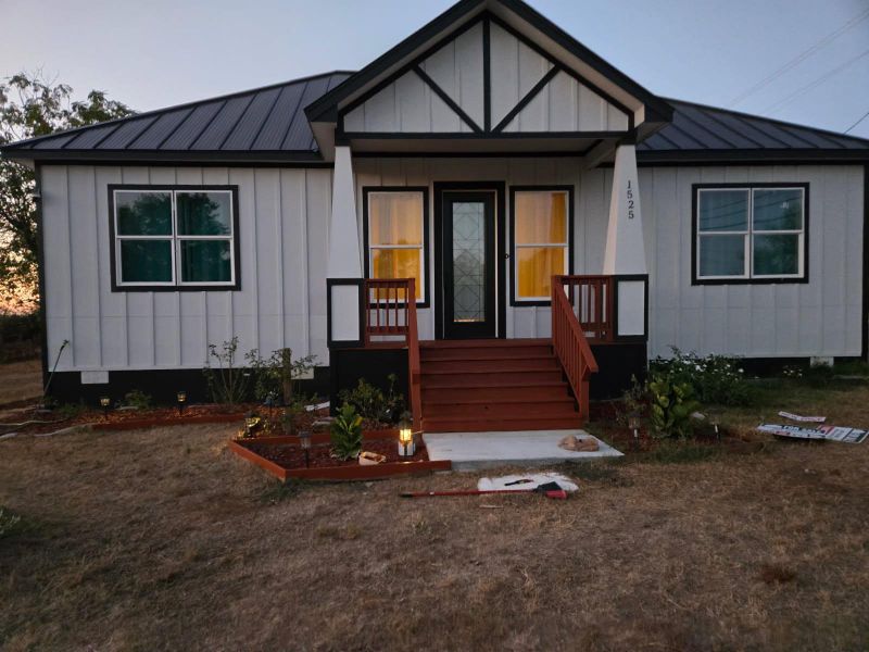 View of front of property with board and batten siding, a metal roof, a standing seam roof, and covered porch