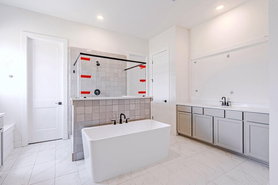 Luxurious soaking tub paired with a spacious walk-in shower and chic tile design