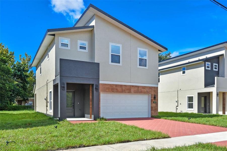 Front exterior of a new home in , Orlando, FL, highlighting curb appeal (Image 2).