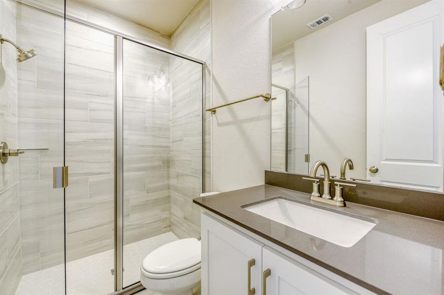 Full bathroom featuring a stall shower and vanity