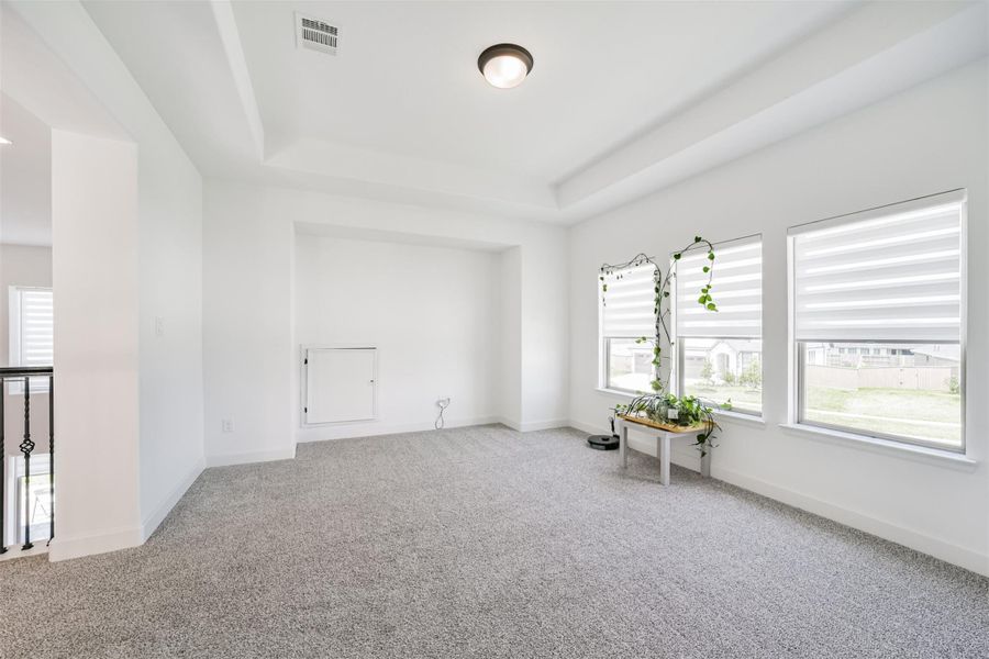 Spacious upstairs game room featuring a cozy computer nook and elegant coffered ceilings—perfect for hosting and entertaining. Spacious upstairs game room featuring a cozy computer nook and elegant coffered ceilings—perfect for hosting and entertaining.