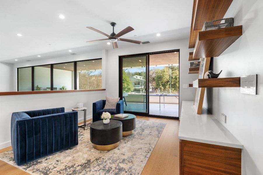 Living area featuring baseboards, recessed lighting, a ceiling fan, visible vents, and wood finished floors Living area featuring baseboards, recessed lighting, a ceiling fan, visible vents, and wood finished floors