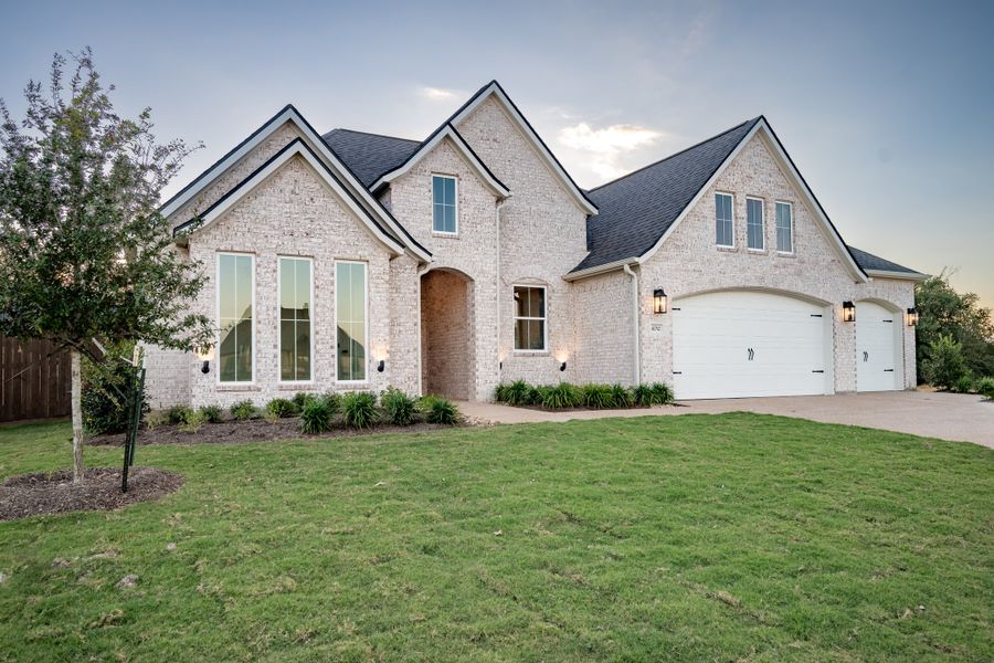 Front exterior of a new home in Greens Prairie Reserve, College Station, TX, highlighting curb appeal (Image 2). Front exterior of a new home in Greens Prairie Reserve, College Station, TX, highlighting curb appeal (Image 2).
