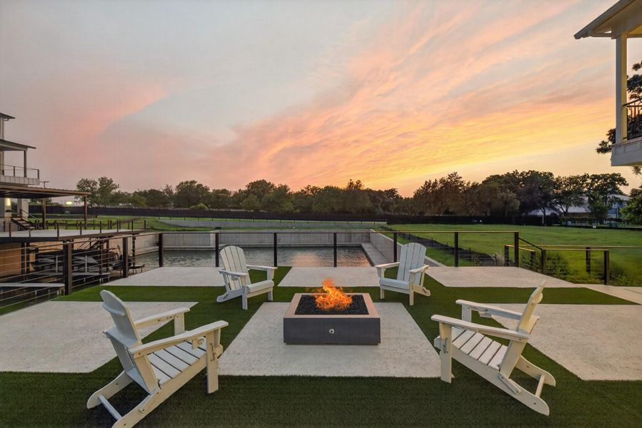 An inviting fire pit area with seating overlooks serene water features at sunset. An inviting fire pit area with seating overlooks serene water features at sunset.