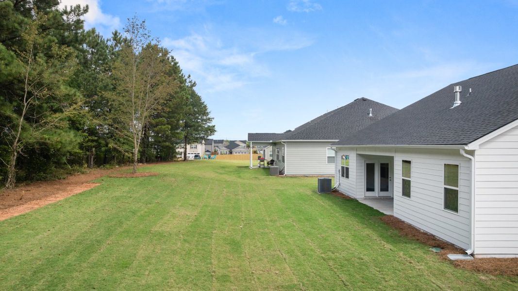 Exterior details and patio area of a home in Preserve at Dove Creek, Statham (Image 3).