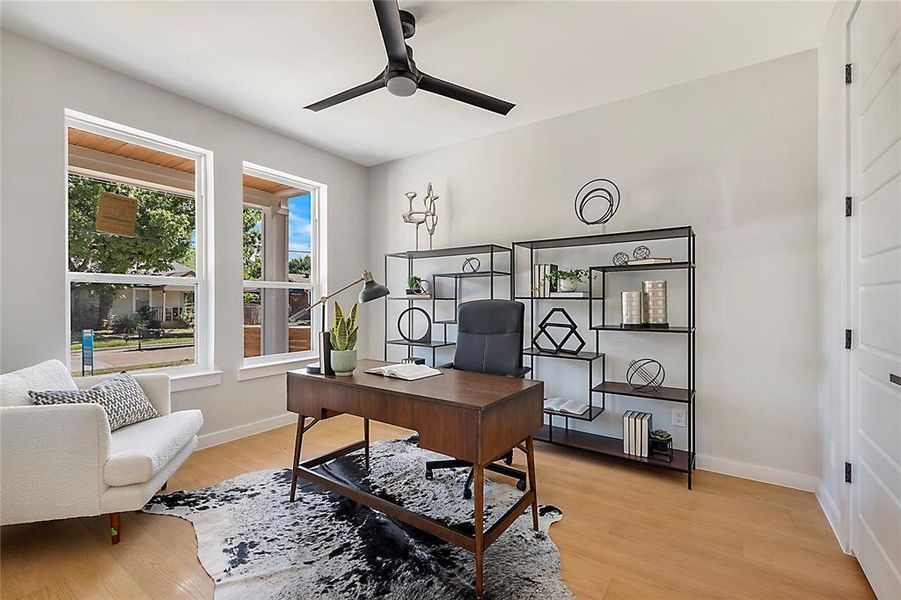 Home office featuring ceiling fan and light wood-type flooring