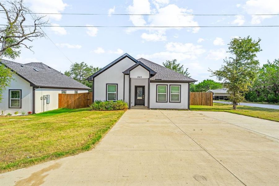 View of front of home featuring driveway, stucco siding, and roof with shingles View of front of home featuring driveway, stucco siding, and roof with shingles