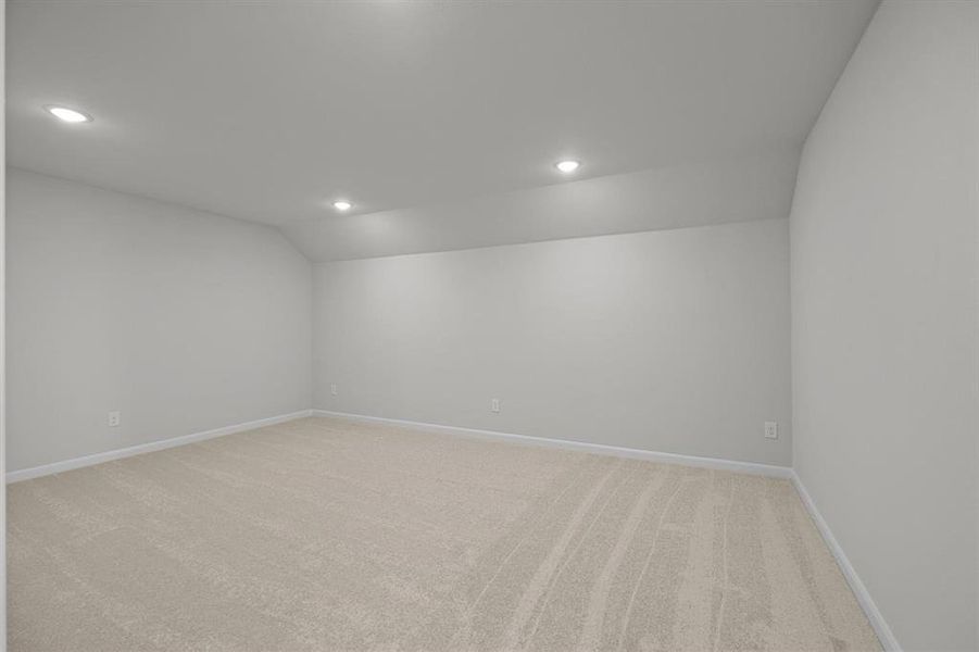 Carpeted room with recessed lighting and neutral wall finishes Carpeted room with recessed lighting and neutral wall finishes