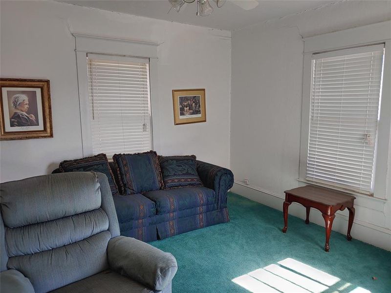 Room featuring light-colored walls and a wall-to-wall carpet Room featuring light-colored walls and a wall-to-wall carpet