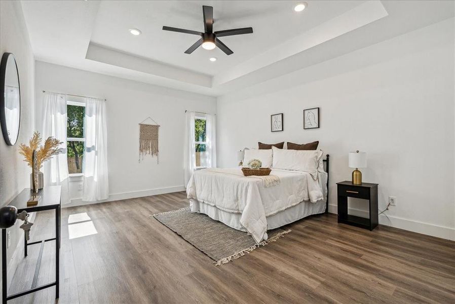 Primary bedroom with vaulted ceilings and tons of natural light