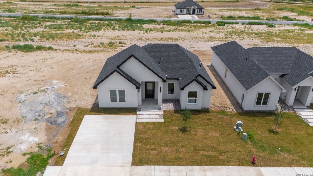 Front exterior of a new home in , Eagle Pass, TX, highlighting curb appeal (Image 2). Front exterior of a new home in , Eagle Pass, TX, highlighting curb appeal (Image 2).