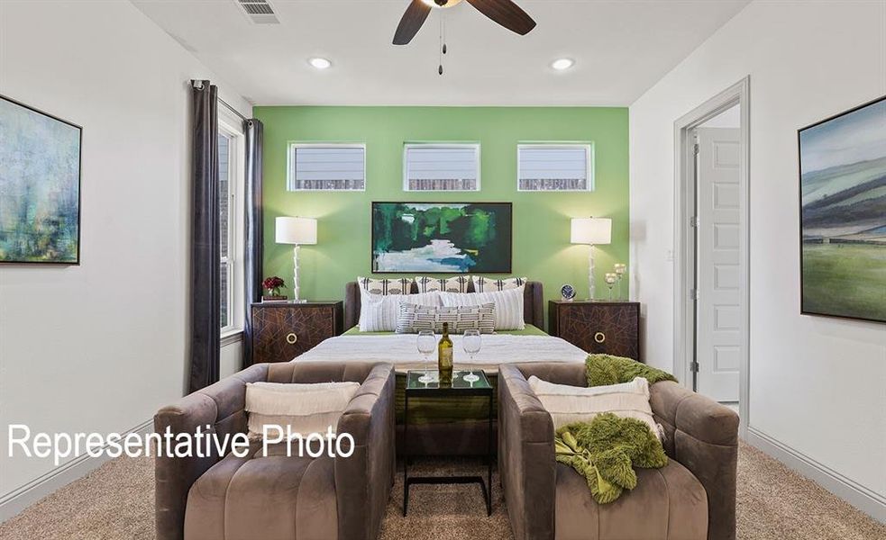 Bedroom featuring a striking accent wall, carpeted flooring, a ceiling fan with integrated lighting, and three transom windows with blinds Bedroom featuring a striking accent wall, carpeted flooring, a ceiling fan with integrated lighting, and three transom windows with blinds
