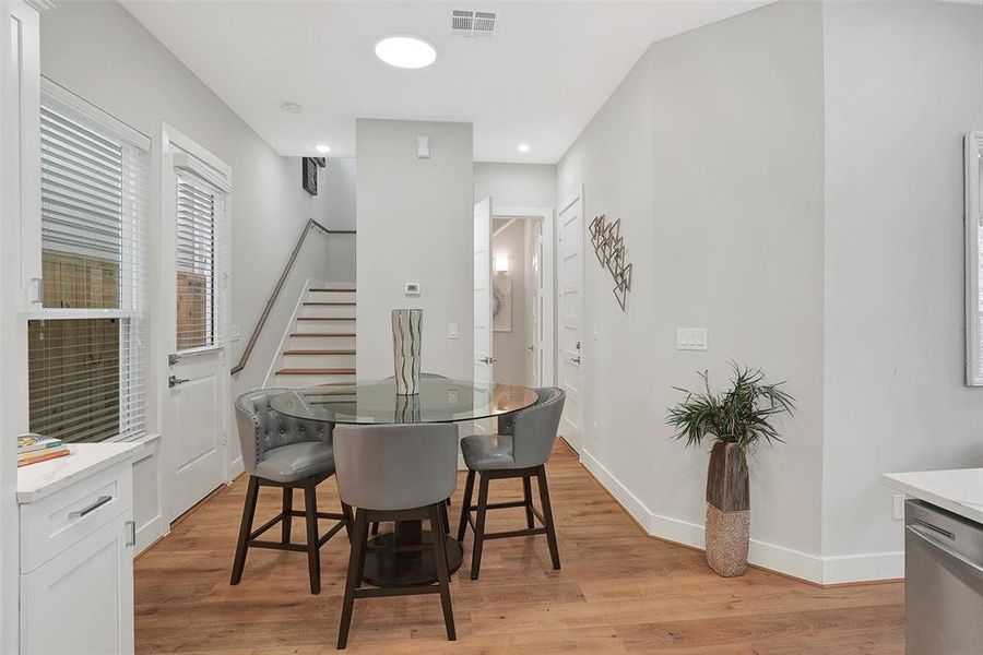 The dining room has access to the back of the house. To the right is the 2 car garage and across from the garage is a hall closet. At the end of the hallway is the powder bathroom.