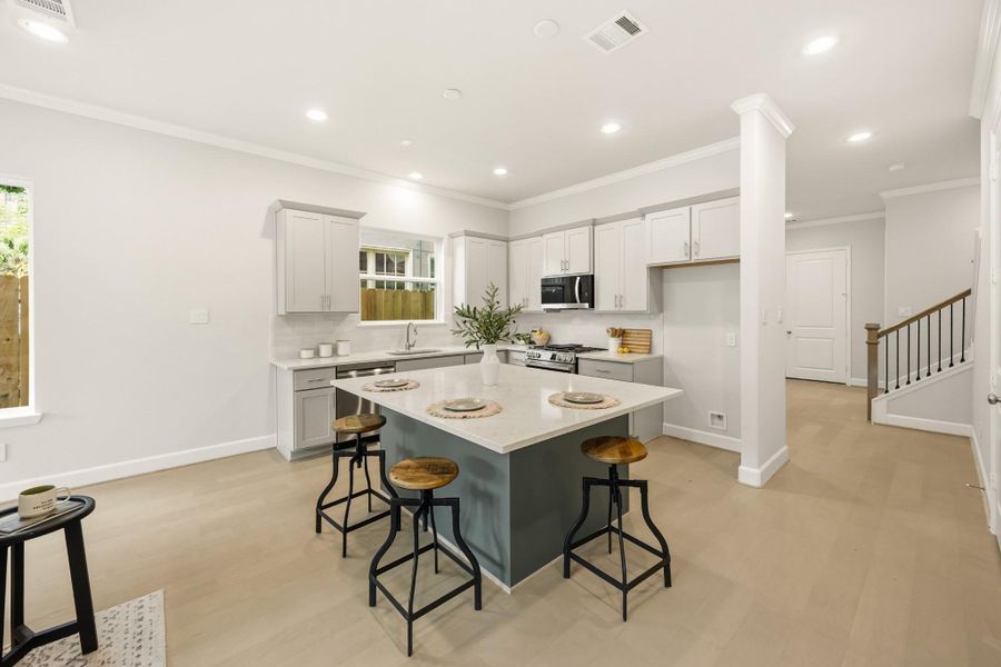 An alternate view unveils the kitchen’s grand island, serving as the heart of the home, with an inviting passage to the adjacent dining room, where memories await to be made. An alternate view unveils the kitchen’s grand island, serving as the heart of the home, with an inviting passage to the adjacent dining room, where memories await to be made.