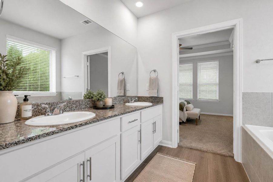 Primary Rm Bathroom with shower and tub combo facing east.