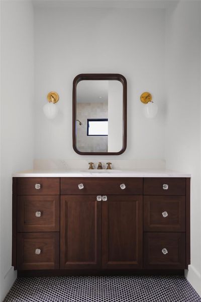 This guest bathroom is designed to feel like a private retreat, featuring a neutral color palette and high-end finishes that encourage a sense of calm. The spacious layout and soft, natural lighting transform a functional room into a quiet, spa-inspired sanctuary for visitors.
