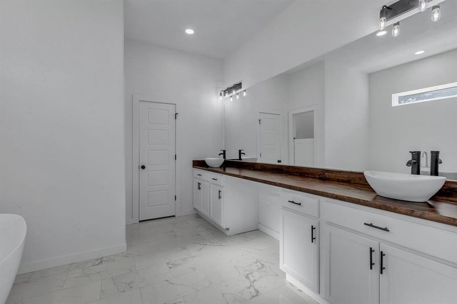 Bathroom featuring a tub and vanity