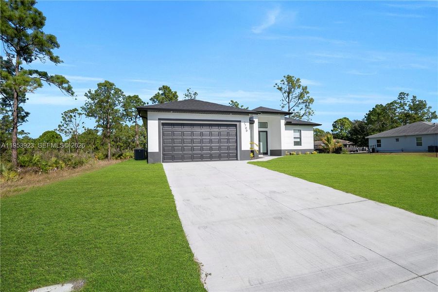 Front exterior of a new home in , Lehigh Acres, FL, highlighting curb appeal (Image 26).