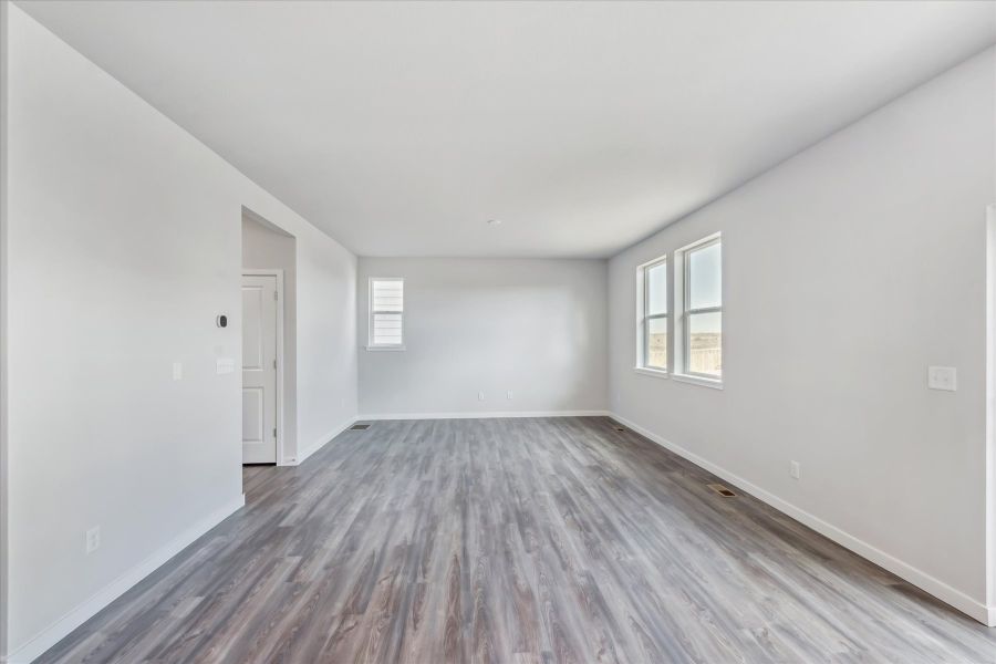 A room with a wood floor and a white door.