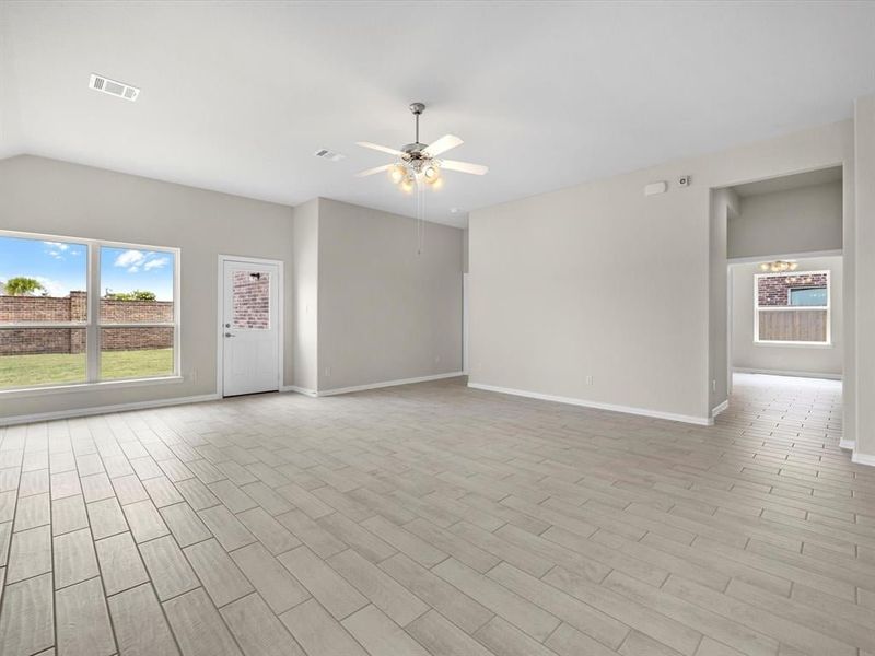 A room with a tile floor and a ceiling fan. A room with a tile floor and a ceiling fan.