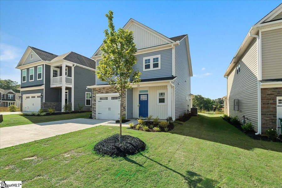 Front exterior of a new home in Halton Oaks, Spartanburg, SC, highlighting curb appeal (Image 2). Front exterior of a new home in Halton Oaks, Spartanburg, SC, highlighting curb appeal (Image 2).