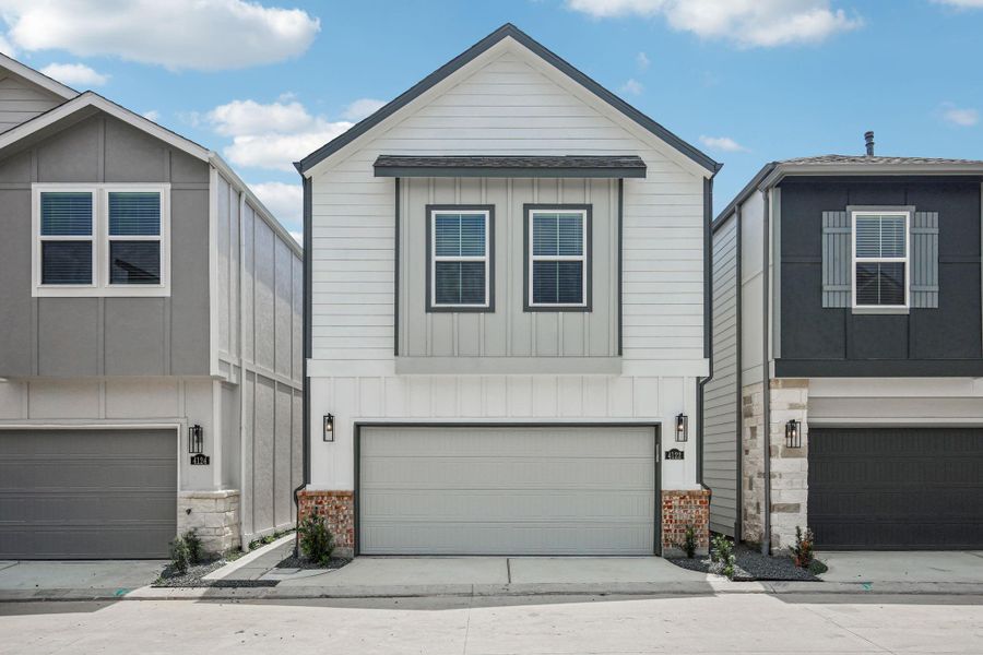 Front exterior of a new home in Spring Brook Village - City Series, Houston, TX, highlighting curb appeal (Image 24). Front exterior of a new home in Spring Brook Village - City Series, Houston, TX, highlighting curb appeal (Image 24).
