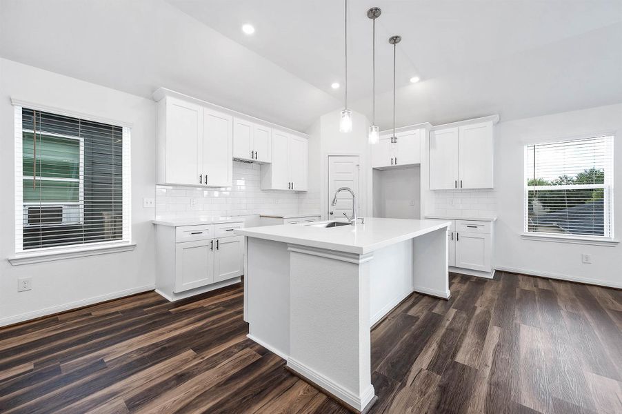 An island with breakfast bar seating is perfect for guests to hang out. An island with breakfast bar seating is perfect for guests to hang out.