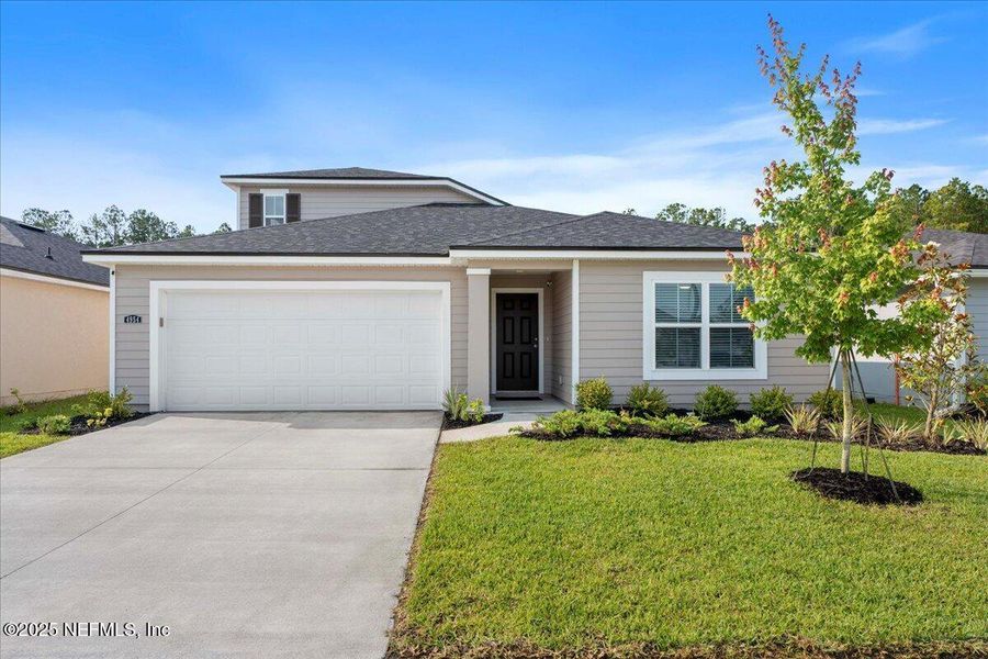 Front exterior of a new home in Dunns Crossing, Jacksonville, FL, highlighting curb appeal (Image 26). Front exterior of a new home in Dunns Crossing, Jacksonville, FL, highlighting curb appeal (Image 26).