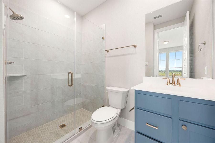 This secondary bedroom enjoys its own private en-suite bath with a walk-in shower and stylish blue vanity. This secondary bedroom enjoys its own private en-suite bath with a walk-in shower and stylish blue vanity.