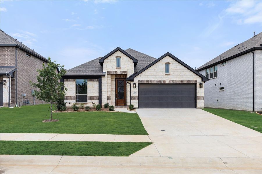 Single-story home with light stone exterior, two-car garage, and manicured front lawn Single-story home with light stone exterior, two-car garage, and manicured front lawn